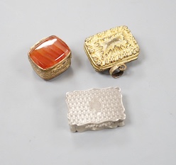 A Victorian engraved silver shaped rectangular vinaigrette, Alfred Taylor, Birmingham, 1850, 27mm and two other gilt metal vinaigrettes, one with inset agate lid.